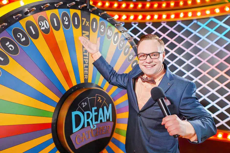 Dream Catcher Casino Game live show by Evolution Gaming featuring a host presenting the colorful money wheel.