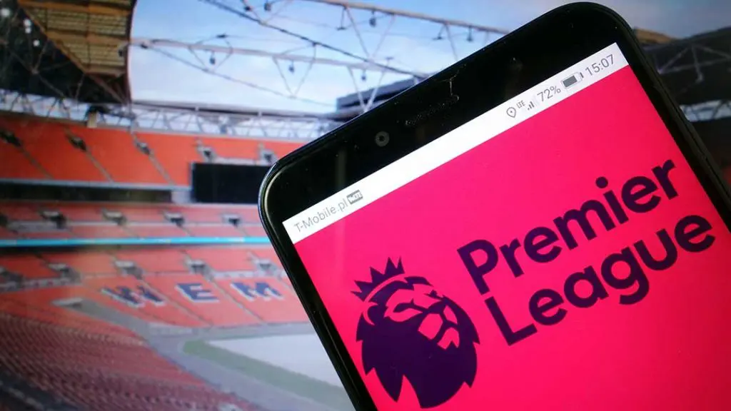 Premier League football shown on a smartphone in a stadium